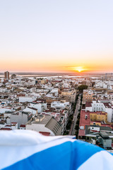 Aerial view of the sunset in Huelva, with the white and blue flag of the 
