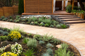 Obraz premium stone path with decorative bushes in the park