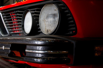 Close-up of headlights of red vintage car