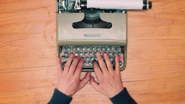 Book writing by the window with a vintage typewriter. 4K video colors and black and white
