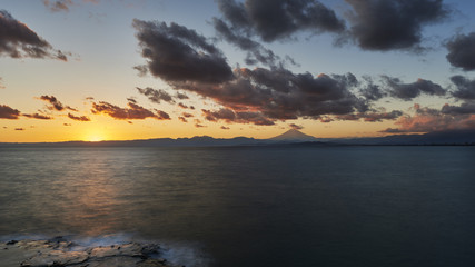 Fototapeta na wymiar Long exposure of dramatic clouds over Mount Fuji at sunset, Kanagawa Prefecture, Japan