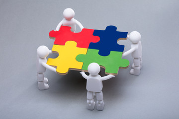 Human Figures Solving Jigsaw Puzzles