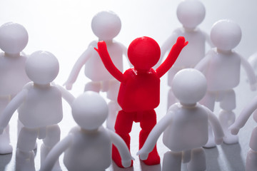 Fototapeta na wymiar Red Human Figure Surrounded By Team