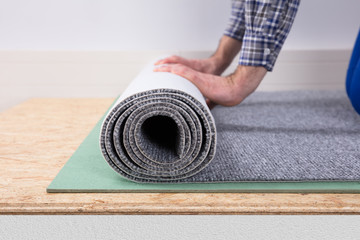 Close-up Of A Worker Installing Carpet
