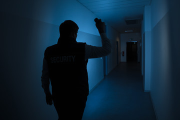 Security Guard Standing In Corridor Of The Building