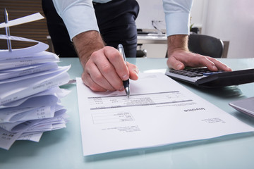 Human Hand Calculating Invoice