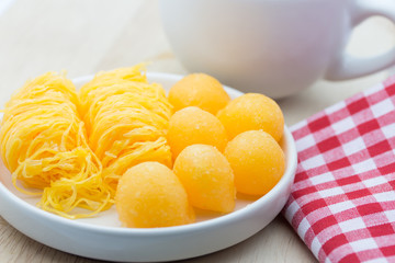 Thai dessert made from yolk egg and sugar on white plate