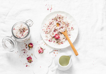 Homemade edible coconut rose sugar scrub on light background, top view. Making home product...