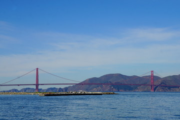 Golden gate bridge with mountain background.