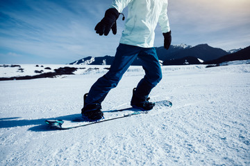 one snowboarder snowboarding in winter mountains