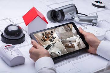 Person Watching Footage On Digital Tablet