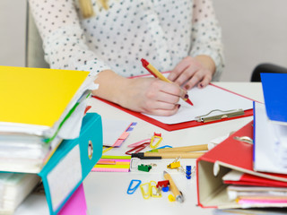 Business woman in office writing something down