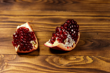Ripe pomegranate fruit on wooden table