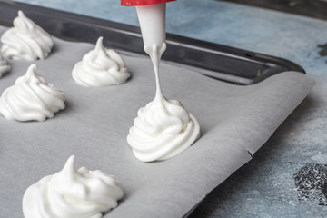 Whipped cream on baking paper. Meringue of the proteins and sugars. Step-by-step recipe for...