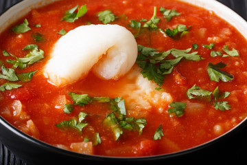 Delicious fish tomato stew with vegetables close-up in a bowl on the table. horizontal