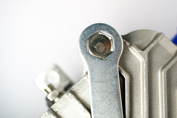 wrench twisting hex nut on metal part