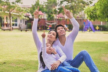 Happy male and female playing with children outside