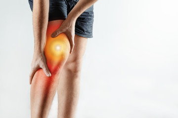 The man holds his hands to the knee, pain in the knee highlighted in red, arthritis, arthrosis,...