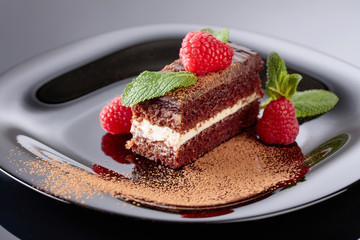 Chocolate cake with raspberry and mint .