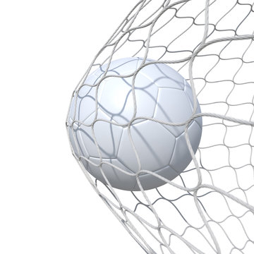 White clear leather soccer ball inside the net, in a net.