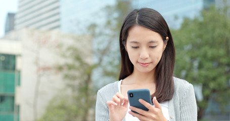 Business woman read on cellphone at outdoor