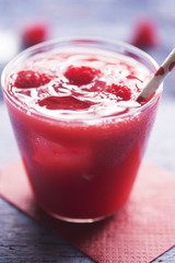 Summer berry juice with ice and raspberries 