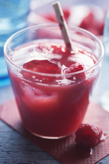 Summer berry juice with ice and raspberries 