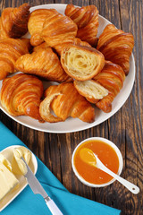 french croissants with flaky texture on plate