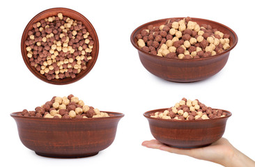set of different Chocolate breakfast cereal in bowl with hand, isolated on white background, brown and white balls, healthy morning food