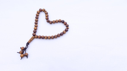 Closeup of  tasbih or rosary on a white background. Selective focus and copy space.