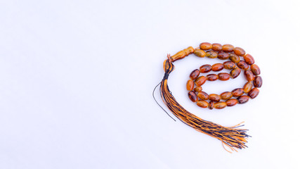 Naklejka premium Closeup of tasbih or rosary on a white background. Selective focus and copy space.