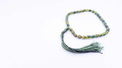 Fototapeta premium Closeup of tasbih or rosary on a white background. Selective focus and copy space.