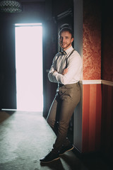 stylish bearded groom posing at the hotel. wedding photo