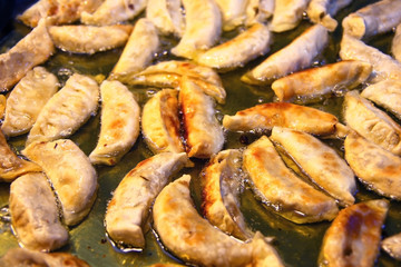 Pun Sip Neung or Pun Clip Neung, Asian fried dumplings cooking as street food, Bangkok, Thailand.