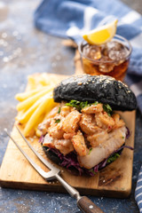 Black burger with fish and shrimps. Fishburger with prawns