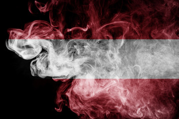 National flag of Austria from dense colored smoke on a black isolated background
