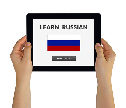 Hands holding digital tablet computer with learn Russian concept on screen. Isolated on white. All screen content is designed by me