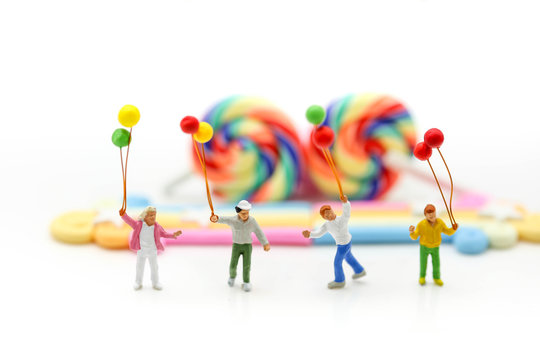 Miniature people : children,students with Colorful of candies and lollipops,education and food concept.