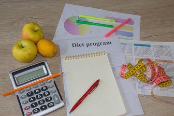 Scale with healthy heart message and measuring tape on table