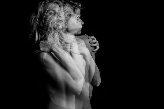 Creative dramatic portrait of young blonde woman holding herself. triple exposure. Black and white photo