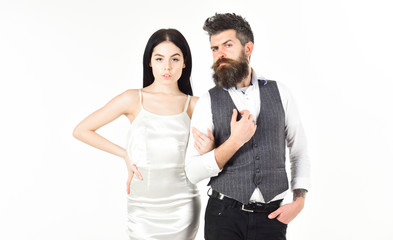 Bearded hipster with bride dressed up for wedding ceremony. Woman in wedding dress and man in vest. Couple in love, bride and groom in elegant wedding clothes, white background. Wedding concept.