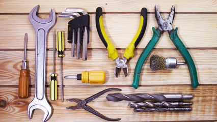 Locksmith tools on wooden background.