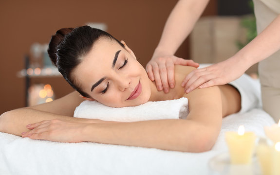 Young woman receiving massage in spa salon