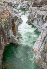 Fototapeta na wymiar fantastic view of a mountain river carving ist way through a wild rocky gorge