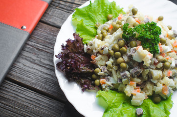 Russian winter salad, the lettuce leaf decor brown wooden background.