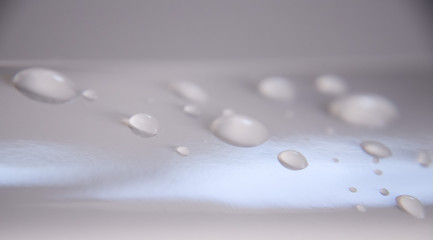 water drops on gray surface with color gradient