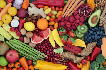 Fruit and vegetable health food to maintain a healthy heart with super foods high in antioxidants, anthocyanins, fibre, vitamins and minerals. Top view background.