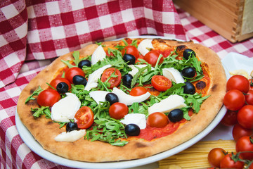 Traditional Italian vegetarian pizza in restaurant on a street in Milan, Italy. Food background.