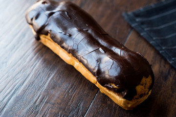 Chocolate Eclairs on Wooden Surface.