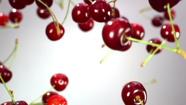 Close-up of cherry rotates in the air on a white background